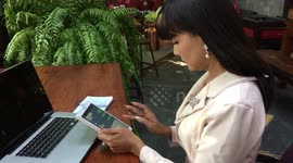 Thai woman using tablet in garden office