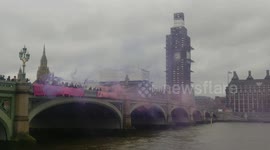 Protesters drop banner from Westminster Bridge in support of Stansted 15
