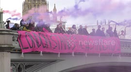 Protesters drop banner from Westminster Bridge in support of Stansted 15