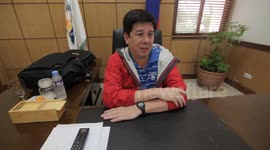 Mayor of Tacloban talks about Typhoon Hagupit while wind rages outside