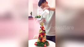 Romantic husband makes edible fruity Christmas tree for his wife