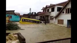 Heavy Floods carrying away houses and buses.