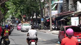 Worker sitting on scaffolding while riding in pick-up truck
