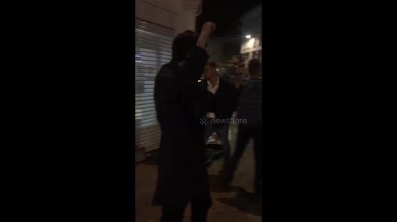 Football Fans Singing with a Busker in Brighton