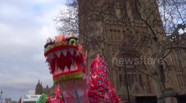 Chinese Dragon entertains visitors to London New Year Day Parade 2019, followed by mini cars, Rolls Royces and Blood Bikers