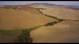 Aerial, gorgeous tuscan fields landscape near the city of Volterra