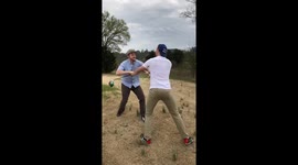 Two Friends Stage A Fight On A Golf Course