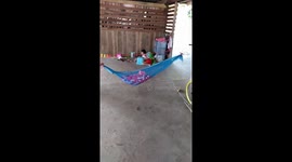 Ingenious way of rocking baby using hammock, fan and bicycle wheel