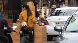 Motorcycle passengers carrying strange objects