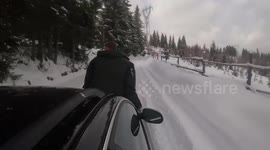 Riding car hood in snow