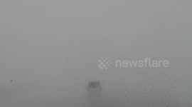 Driver navigates through harrowing zero-visibility road during Finland winter