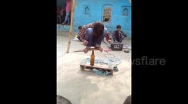 This Indian boy can spin right round on the head of a bottle