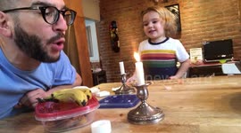 Dad entertains his kid by beatboxing with a candle flame