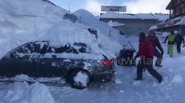 Parked car reverses while under 6ft-high snowdrift in Austrian hotel car park
