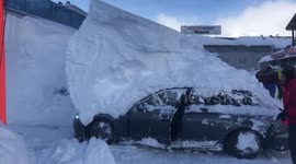 Parked car reverses while under 6ft-high snowdrift in Austrian hotel car park