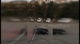 Power lines spark dangerously after being brought down by building demolition