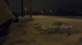 Man snowblowing driveway