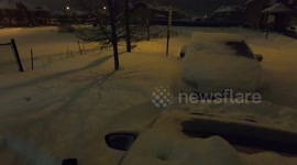 Man snowblowing driveway after snowstorm