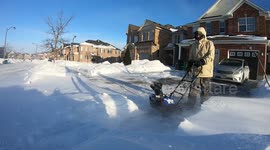 Man snowblowing on windy day 60FPS good audio