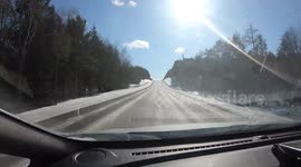 Timelapse shows car driving on lengthy straight Canadian road in winter