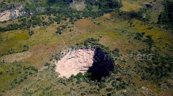 People hiking to the Oyo El Cimarron, a deep hole in the northern Guatemala