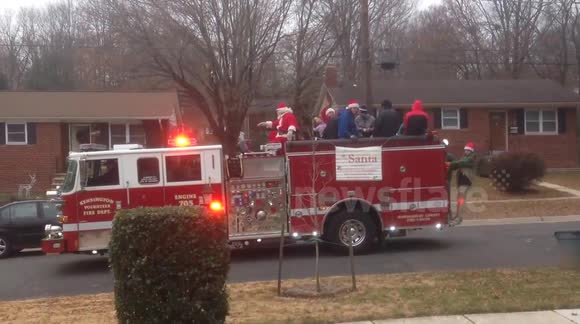 Santa Claus parades through Maryland neighbourhood on a fire truck