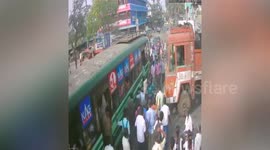 Shocking incident: Truck rampage into government bus, while a scooter riders escape death by rolling under the truck in southern India.