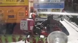 Two motorcyclists stuck in traffic play rock, paper scissors (edited)