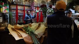 Flower shop worker cuts long-stem roses on eve of Valentine’s Day