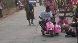 Father and daughter ride in miniature pink motorbike and sidecar for Valentine's Day