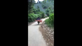 The woman riding the motorbike and carrying three children sit behind very dangerous
