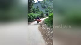 Newsflare Edit - The woman riding the motorbike and carrying three children sit behind very dangerous