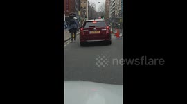 Rollerblading man gets free ride by hanging onto back of car