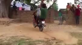 Bike tied to tree branches, Indian men enjoy swing ride