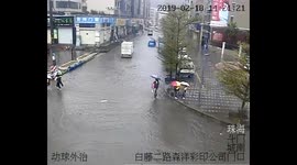 Good samaritans carry children across flooded road in China’s Guangdong