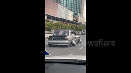 Car driving on 'slanted wheels' seen on the roads of Malaysia