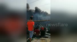 Newsflare Edit - Tens of people watch at the port as fishermen boats burned out in Jakarta, Indonesia