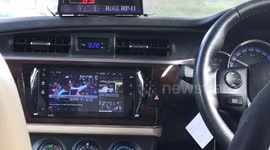 Bangkok taxi driver watches TV in his modified dashboard