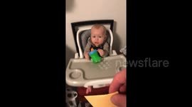 Hilarious moment Michigan dad tosses cheese slice, landing it on baby's face