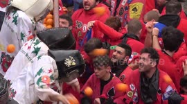 Food fight! Italians beat the pulp out of each other in annual Battle of the Oranges carnival