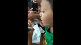 A Boy Enjoys His Ice Cream Until The Last Drop