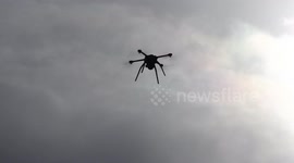 Angry looking drone with camera hovers over Toronto