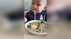 Two-year-old boy uses chopsticks like a pro