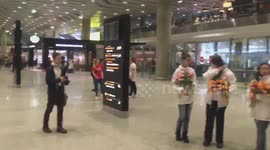 RAW: 	Women gifted with flowers at St. Petersburg airport to mark International Women's Day