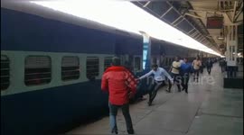 Terrifying moment a man survive as onlookers help him as he was trapped between the platform & train in Northern India.