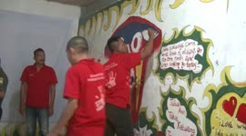 Indonesian prisoners in rehab paint inspirational slogans as part of recovery