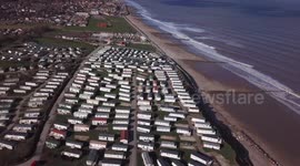 Drone footage shows the cliff erosion which has left homeowners in turmoil - as their properties edge closer to falling onto the BEACH