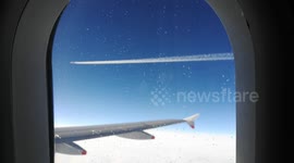 Two planes fly close to each other in the sky