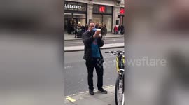 Passionate protester rants into megaphone outside Apple store in London