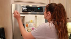 Girl pushes buttons on the oven
